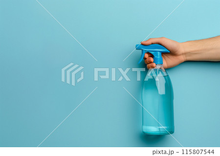 A person is holding a blue spray bottle A person is holding a blue spray bottle 115807544