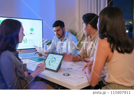 diversity team discusstion about esg and eco friendly system planning in sustainable green office at night 115807911