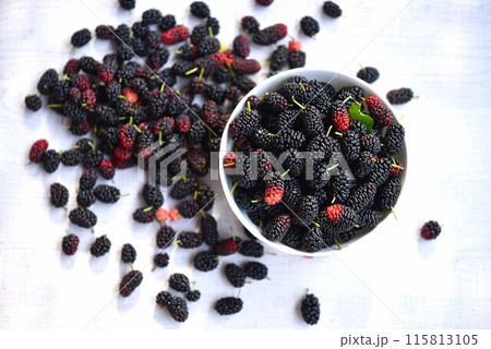 Top view of mulberries bowl on wooden background. Top view of mulberries bowl on wooden background. 115813105
