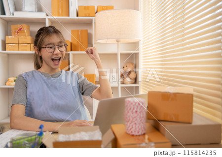 Sell products online, Happy Woman Celebrating Order from Internet Customer: New Business Style, Online Selling, Young Entrepreneur's Success: Work-from-Home SME Owner Thrives in Online Sales. Sell products online, Happy Woman Celebrating Order from Internet Customer: New Business Style, Online Selling, Young Entrepreneur's Success: Work-from-Home SME Owner Thrives in Online Sales. 115814235