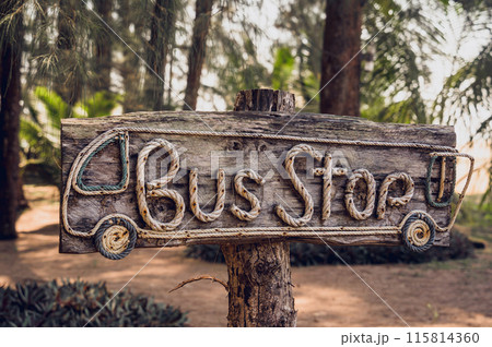 A wooden sign bus stop made with rope letters 115814360