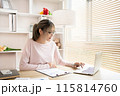 Young woman using a laptop, Work from the comfort of home, Use your laptop for work and communication, Work from home. 115814760