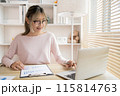 Young woman using a laptop, Work from the comfort of home, Use your laptop for work and communication, Work from home. 115814763
