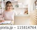 Young woman using a laptop, Work from the comfort of home, Use your laptop for work and communication, Work from home. 115814764