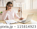 Young woman using a laptop, Work from the comfort of home, Use your laptop for work and communication, Work from home. 115814923