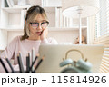 Young woman using a laptop, Work from the comfort of home, Use your laptop for work and communication, Work from home. 115814926