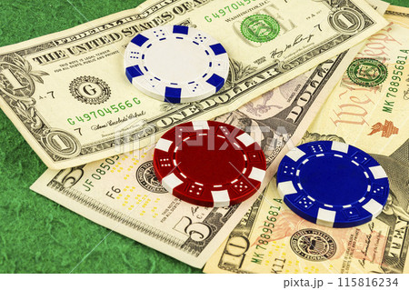 White, red and blue chips lie on bills one, five and ten dollars White, red and blue chips lie on bills one, five and ten dollars 115816234