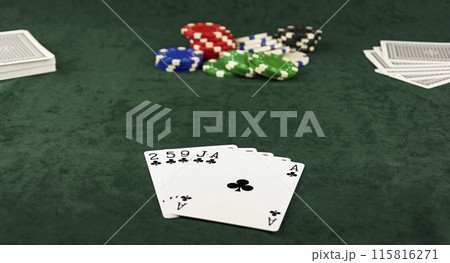 On the green cloth lying Center pot and poker hand of five cards 115816271