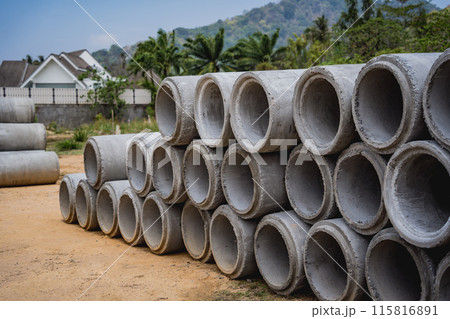 A stack of concrete ring pipes piled and creating a symmetrical arrangement A stack of concrete ring pipes piled and creating a symmetrical arrangement 115816891
