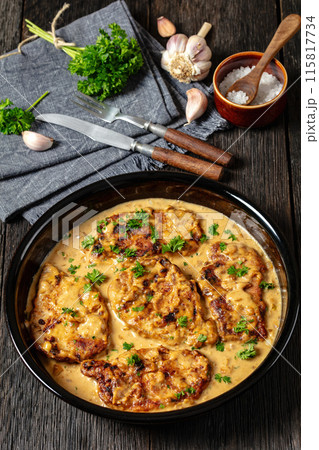 creamy smothered pork chops cooked in onion gravy 115817734