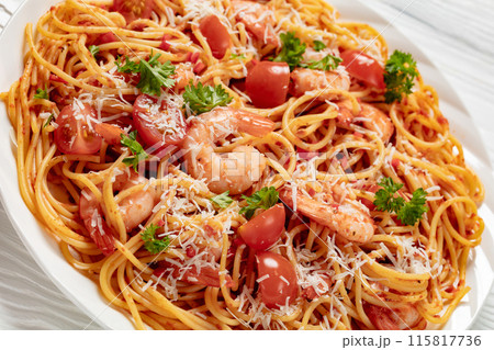 shrimp fra diavolo with spaghetti on a plate 115817736