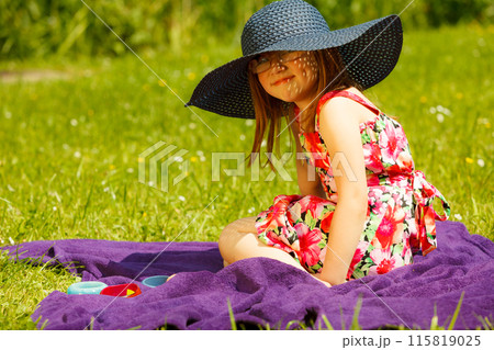 Cute little girl in big hat pretending to be lady 115819025