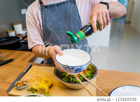 Chef at the kitchen preparing spicy glass noodle salad Chef at the kitchen preparing spicy glass noodle salad 115820730