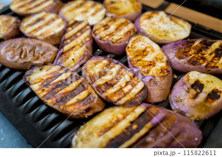 Delicious grilled eggplants with garlic on the electric grill Delicious grilled eggplants with garlic on the electric grill 115822611