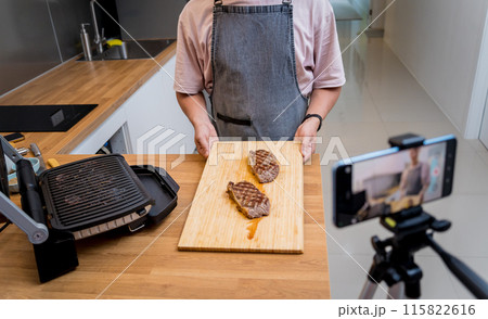 The chef is broadcasting live from workshop how to prepare a beef steaks on the electric grill The chef is broadcasting live from workshop how to prepare a beef steaks on the electric grill 115822616