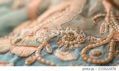 Close-up of detailed embroidery showcasing vibrant beads, sequins, and metallic threads in a floral pattern on fabric.. Close-up of detailed embroidery showcasing vibrant beads, sequins, and metallic threads in a floral pattern on fabric.. 115822876