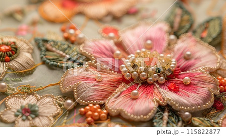 Close-up of detailed embroidery showcasing vibrant beads, sequins, and metallic threads in a floral pattern on fabric.. 115822877