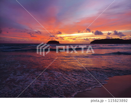 Beautiful sunset on the ocean shore with a view of the islands Beautiful sunset on the ocean shore with a view of the islands 115823892