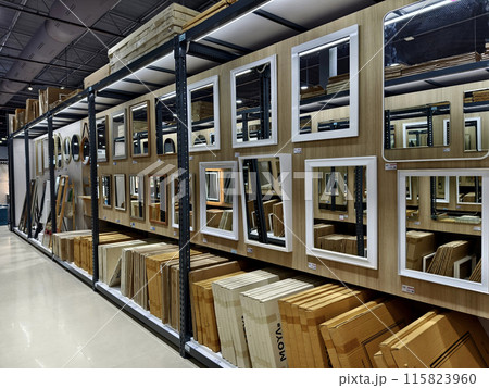 A warehouse packed with numerous mirrors and boxes A warehouse packed with numerous mirrors and boxes 115823960