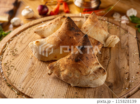 Calzones on wooden board 115828139