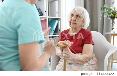 Medical Worker Holds Elderly Woman'S Hand And Calms Her Down 115828322