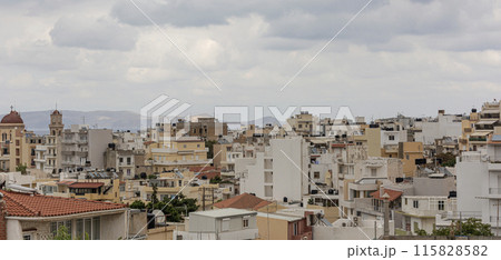 Urban landscape. Dense urban development. Multi-storey buildings under rain clouds Urban landscape. Dense urban development. Multi-storey buildings under rain clouds 115828582