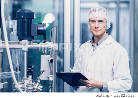 Scientist Medical Factory Staff Working in Science Lab. Medicine factory Technician Employee Check Care Products Quality in Sterilize Room Taking Note in Check list. 115829515