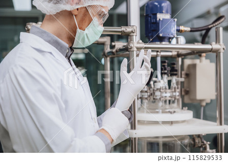 Scientist staff wearing Latex Medical Glove in Science Lab. Medical factory staff in clean room. Pharmaceutical Plants Process. 115829533