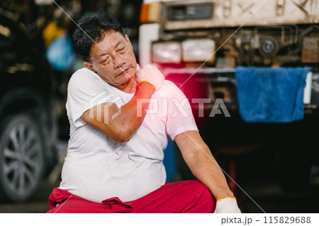 Adult senior Asian worker man muscle join shoulder neck pain syndrome from hard work in heavy industry. 115829688