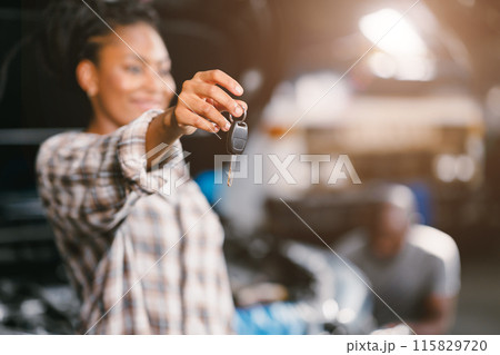 Happy African women showing Car Key smiling for return good healthy car after service replace broken part. Happy African women showing Car Key smiling for return good healthy car after service replace broken part. 115829720