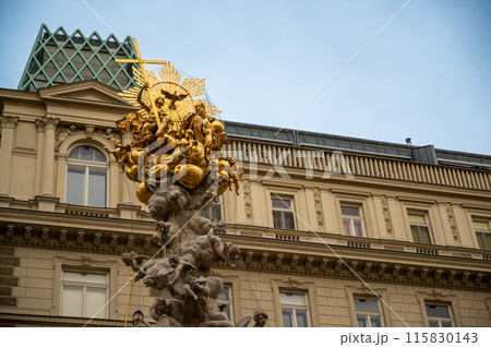 Vienna, Austria, August 18, 2022. In the historic center, detail of the golden top of the Plague Column. Vienna, Austria, August 18, 2022. In the historic center, detail of the golden top of the Plague Column. 115830143