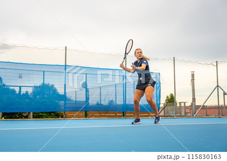 Professional female tennis player playing the tennis on outside court 115830163