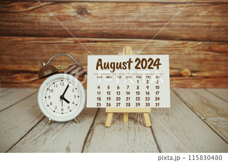 August 2024 monthly calendar on easel stand on wooden background 115830480