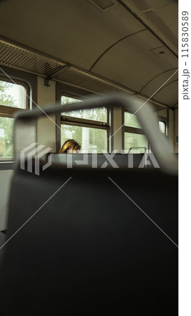 A woman rides in an old train A woman rides in an old train 115830589