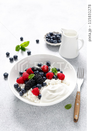 Cheese cottage with yogurt and fresh berries. Curd with blueberry, raspberry and blackberry Cheese cottage with yogurt and fresh berries. Curd with blueberry, raspberry and blackberry 115831278