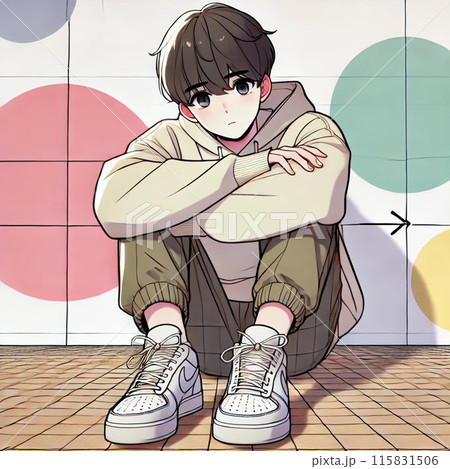 壁にもたれて座っている青年 115831506