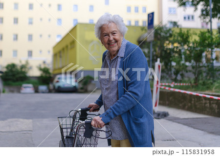 Beautiful elderly woman walking on city street with rollator, going shopping to the store. 115831958