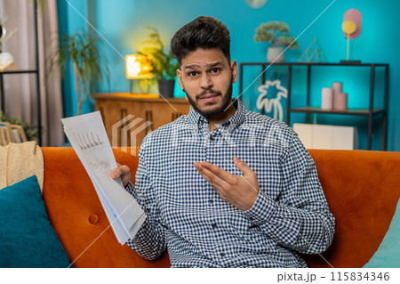 Indian man arguing speaking aggressively during video call showing documents paperwork graph mistake Indian man arguing speaking aggressively during video call showing documents paperwork graph mistake 115834346