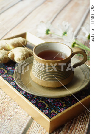 Ginger tea on wooden background. 115836298