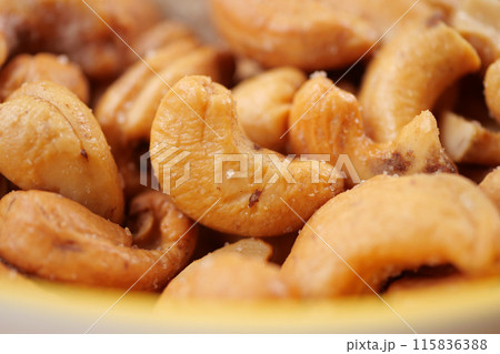cashew nuts in a small bowl on black color background  115836388