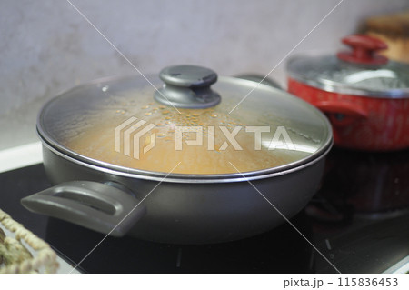 cooking pan on electric stove, electric stove is heated to red. cooking pan on electric stove, electric stove is heated to red. 115836453