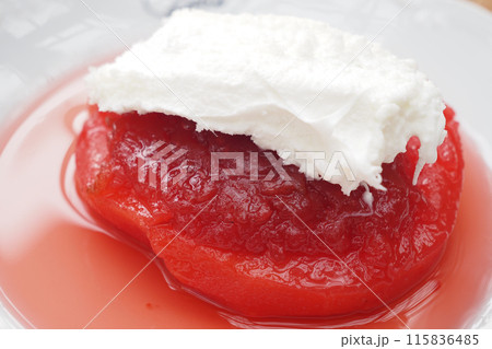 Indulge in a scrumptious red fruit dessert topped with luscious whipped cream for a delightful treat 115836485