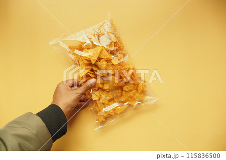 holding a open chips packet top view  115836500