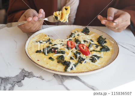 eating Plain Egg Omelette on table  115836507