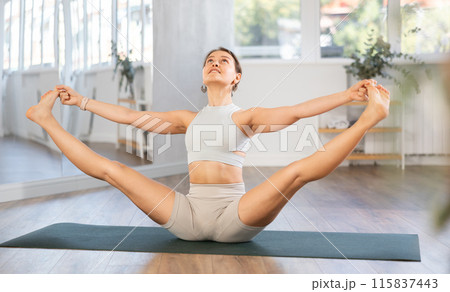 Different yoga poses performed by a slender girl in gym Different yoga poses performed by a slender girl in gym 115837443