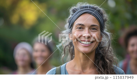 A Woman With Gray Hair Is Smiling In Front Of A Group Of Women 115837949