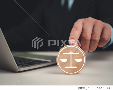 Businessman pointing at circular piece of wood with a scale mark for business legal advice, Labor law, Legal advice business concept, Lawyer icon, Lawyer background, Signing of joint ventures. Businessman pointing at circular piece of wood with a scale mark for business legal advice, Labor law, Legal advice business concept, Lawyer icon, Lawyer background, Signing of joint ventures. 115838053