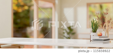 A white tabletop features decorative objects with a blurred background of a minimalist room. 115838922