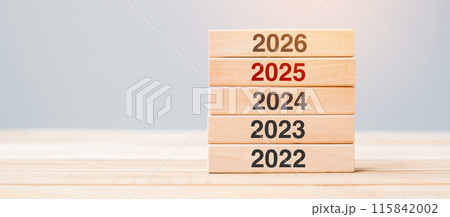2026 block over 2025 and 2024 wooden building on table background. Business planning, Risk Management, Resolution, strategy, solution, goal, New Year New You and happy holiday concepts 115842002
