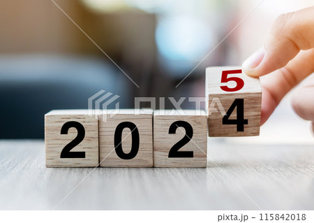 hand flipping block 2024 to 2025 text on table. Resolution, strategy, plan, goal, motivation, reboot, business and New Year holiday concepts hand flipping block 2024 to 2025 text on table. Resolution, strategy, plan, goal, motivation, reboot, business and New Year holiday concepts 115842018